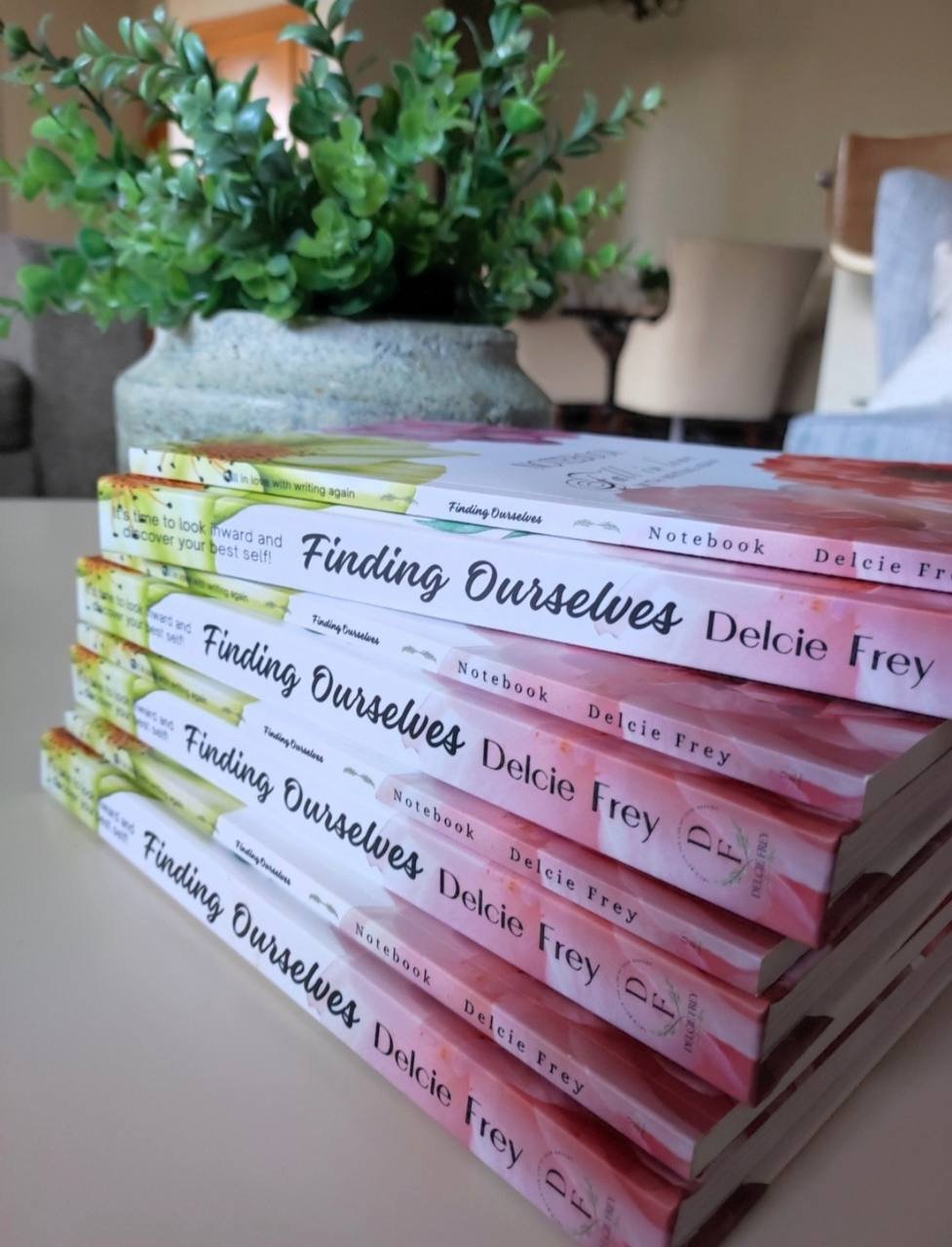 Finding Ourselves books by Delcie Frey stacked on a table